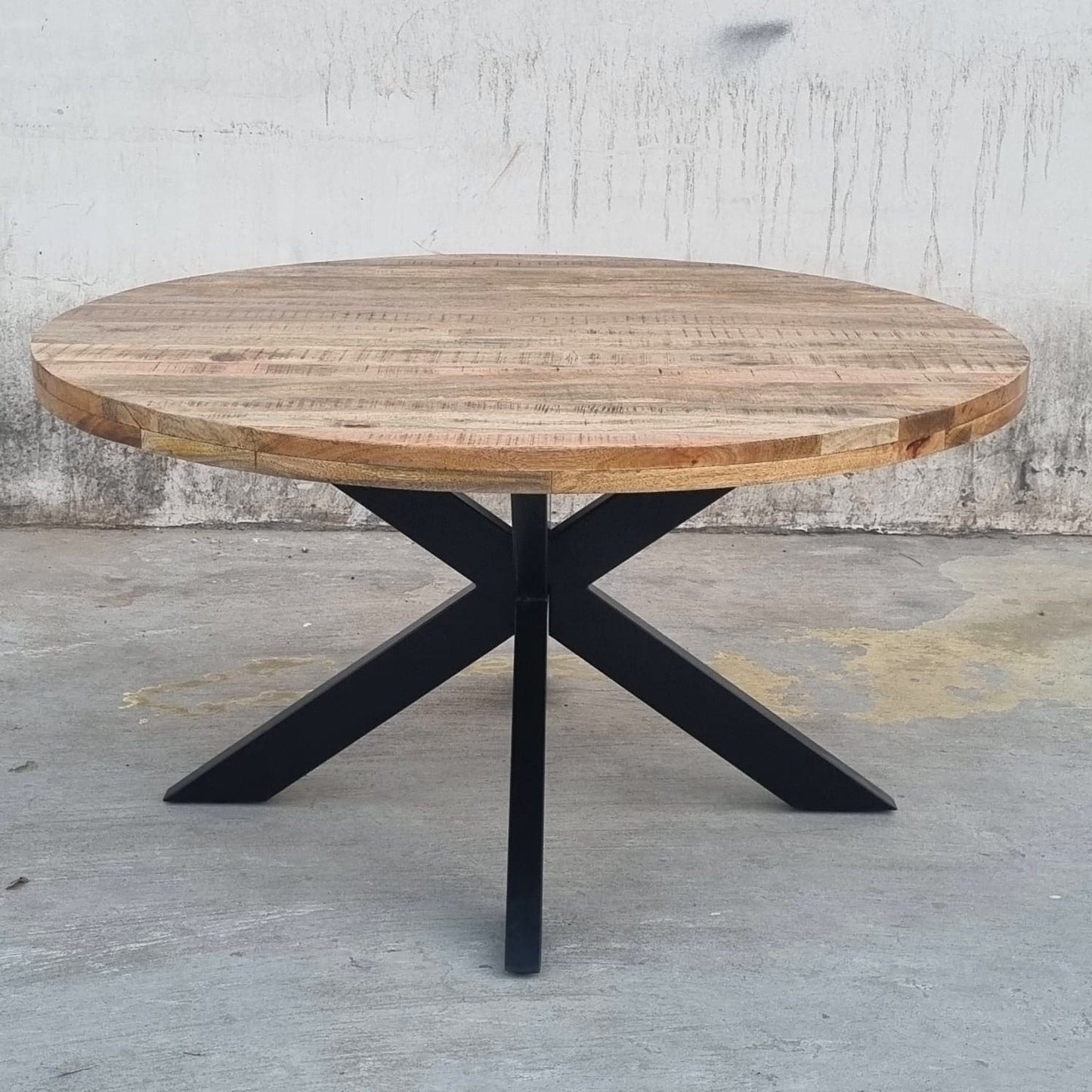 La table industrielle ronde Kukuu a été fabriquée à partir de pieds en métal et d'un plateau en bois massif de manguier. Mesures: 120 (L) x 120 (l) x 78 (H) cm. Kukuu, boutique en ligne de mobilier industriel.