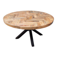 La table ronde herringbone a été fabriquée à partir d'une base en métal et d'un bois en bois massif de manguier. Kukuu, meubles industriels de qualité.